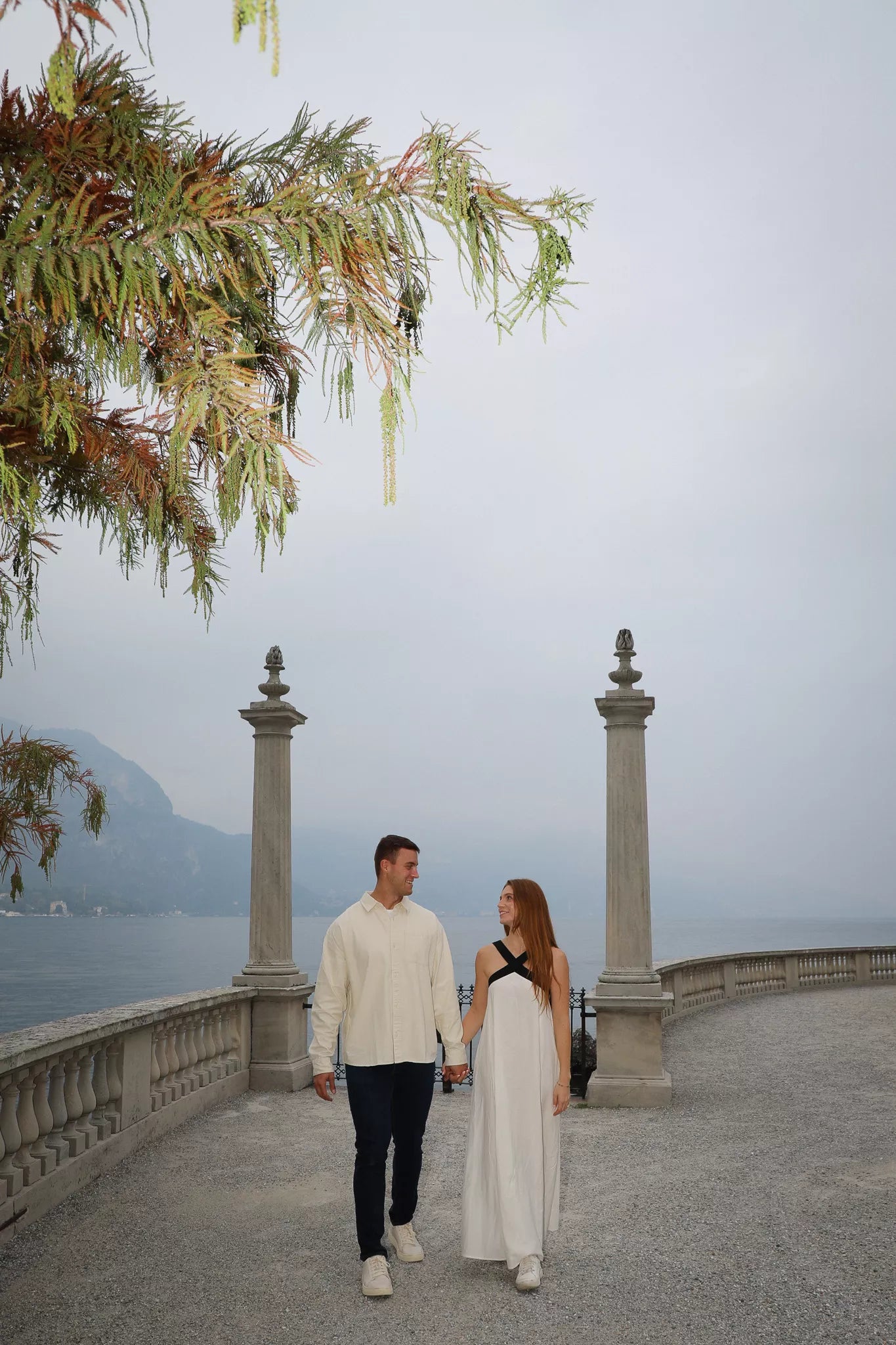 Surprise proposal on the Bellagio lakefront in golden hour light
